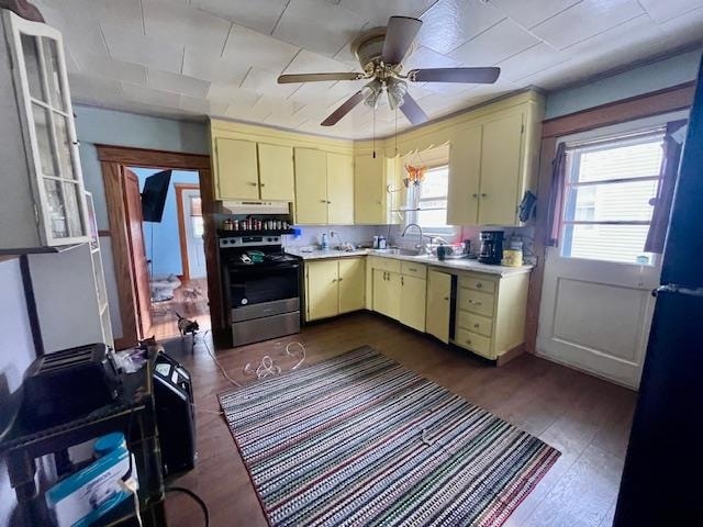 kitchen featuring ceiling fan, dark hardwood / wood-style flooring, a wealth of natural light, and stainless steel range with electric cooktop