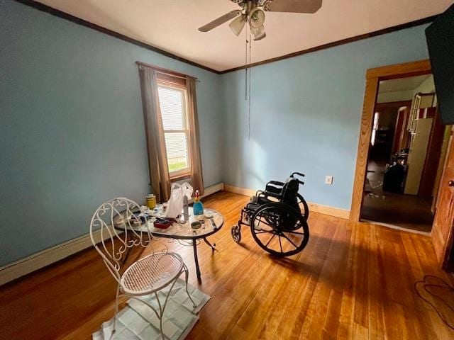 sitting room with crown molding, light hardwood / wood-style flooring, a baseboard heating unit, and ceiling fan