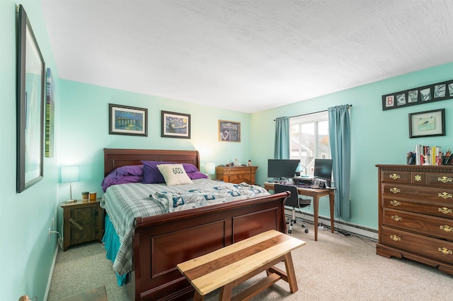 carpeted bedroom featuring a baseboard heating unit and a textured ceiling