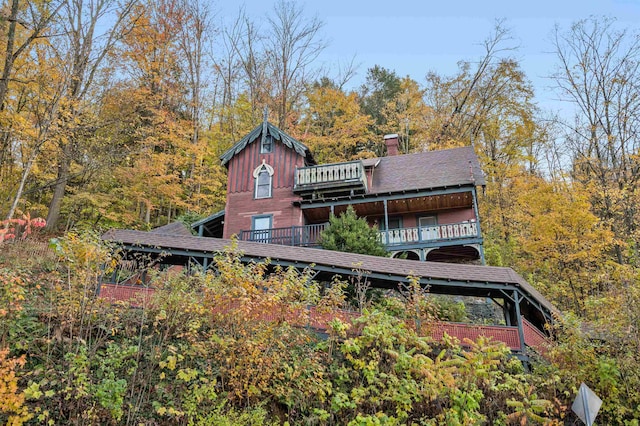 rear view of property featuring a balcony