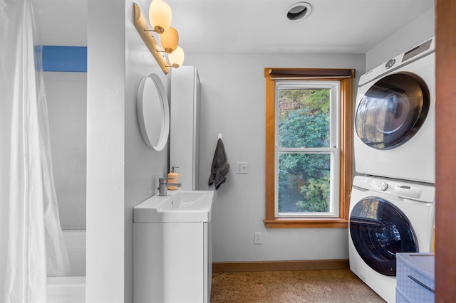 laundry area featuring stacked washer / drying machine