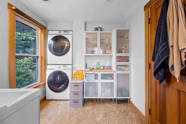 laundry room with stacked washer / dryer