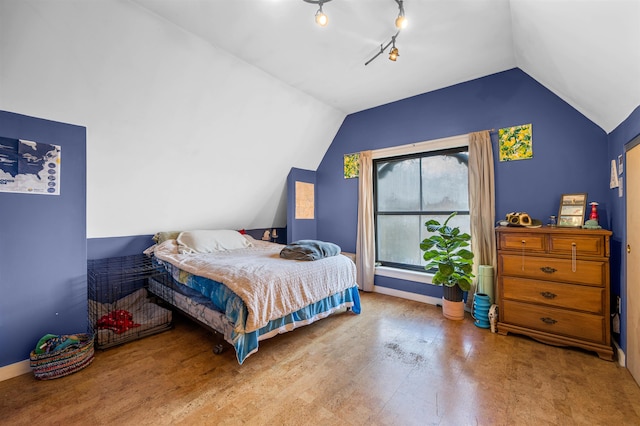 bedroom with wood-type flooring and vaulted ceiling