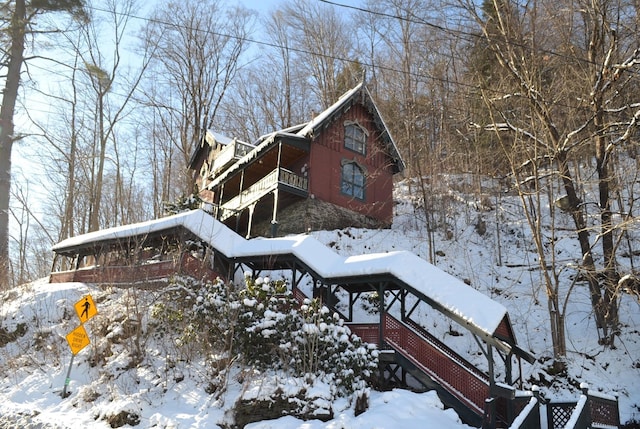 view of snow covered exterior featuring a balcony