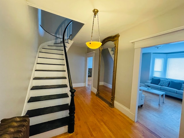 stairs featuring wood-type flooring