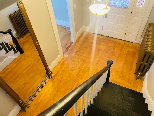 staircase with hardwood / wood-style floors