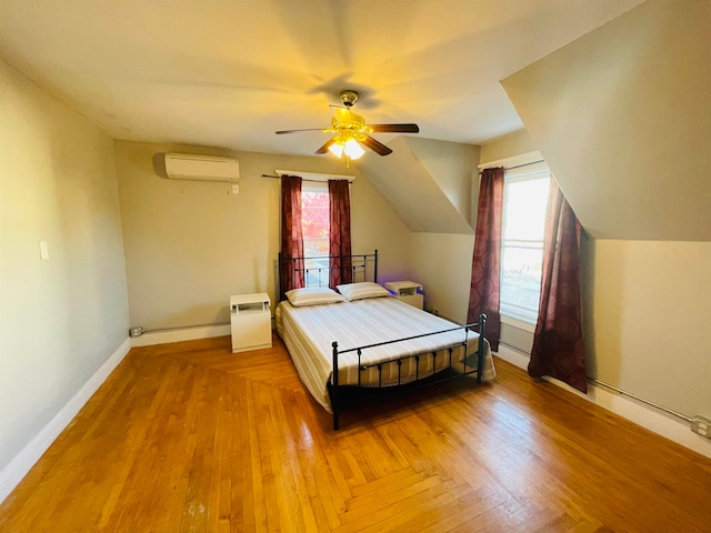 bedroom with a wall mounted air conditioner, multiple windows, lofted ceiling, and ceiling fan