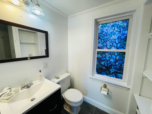 bathroom featuring vanity, toilet, crown molding, and tile patterned flooring