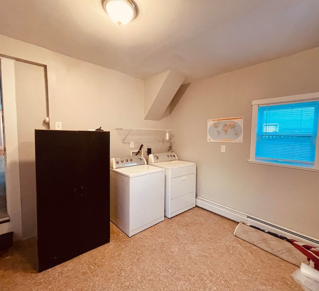 laundry area with a baseboard heating unit and washing machine and clothes dryer