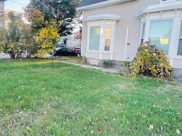 view of property exterior featuring a lawn