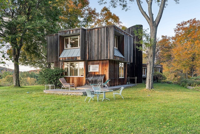 back of property with a lawn