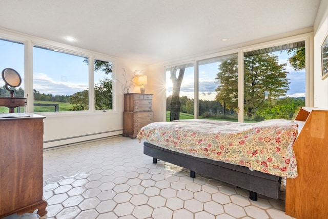 bedroom with multiple windows and baseboard heating