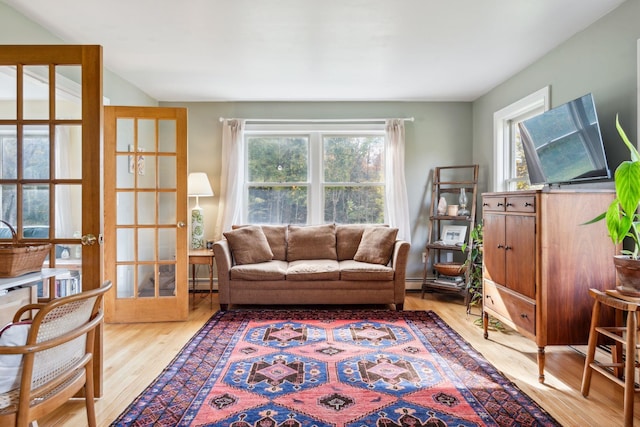living room featuring french doors, wood-type flooring, and a baseboard radiator