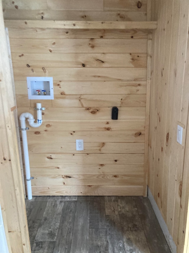 clothes washing area featuring hookup for a washing machine, dark wood-type flooring, and wood walls