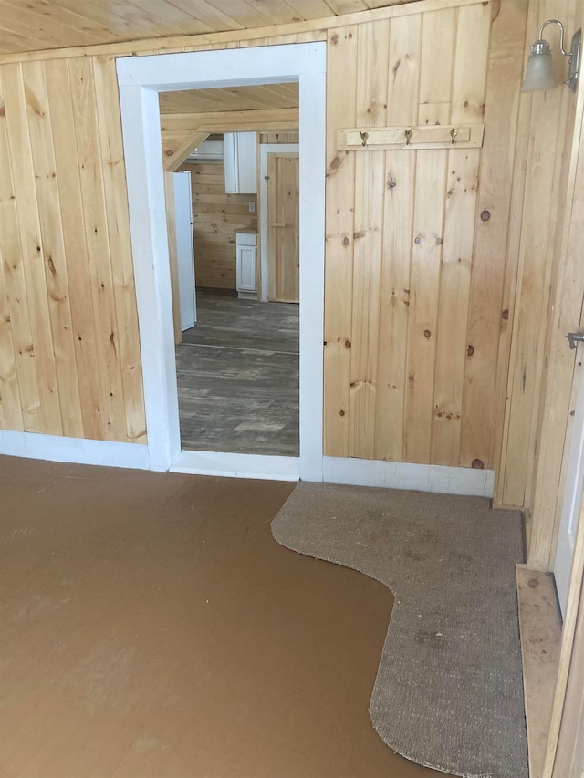 empty room with hardwood / wood-style flooring and wooden walls