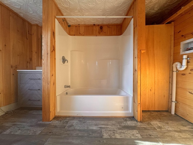 10 N Ave, Richford, VT 05476 - full bathroom with an ornate ceiling, wood finished floors, wooden walls, and washtub / shower combination