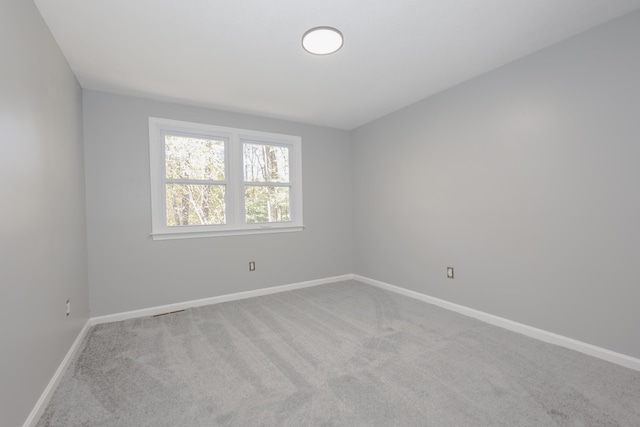 spare room with light colored carpet