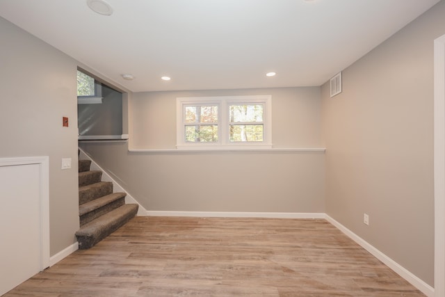 basement with light hardwood / wood-style floors