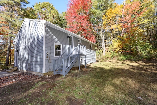 view of side of property with a lawn