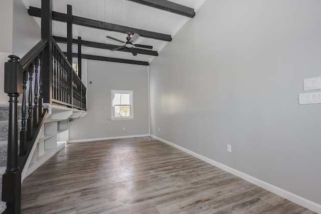 unfurnished living room featuring ceiling fan, beam ceiling, high vaulted ceiling, and hardwood / wood-style floors