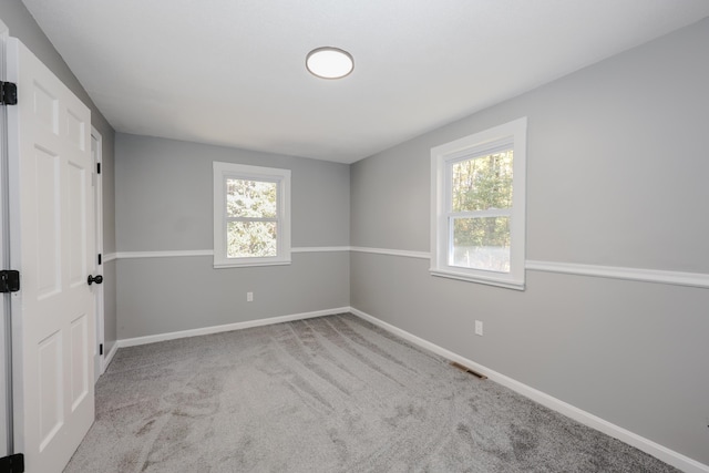 unfurnished room with light carpet