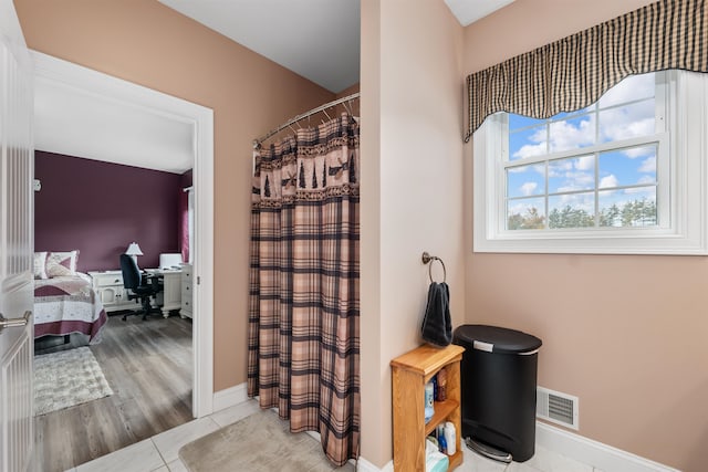 bathroom with a shower with curtain and hardwood / wood-style floors