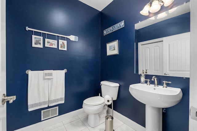 bathroom featuring toilet and tile patterned flooring