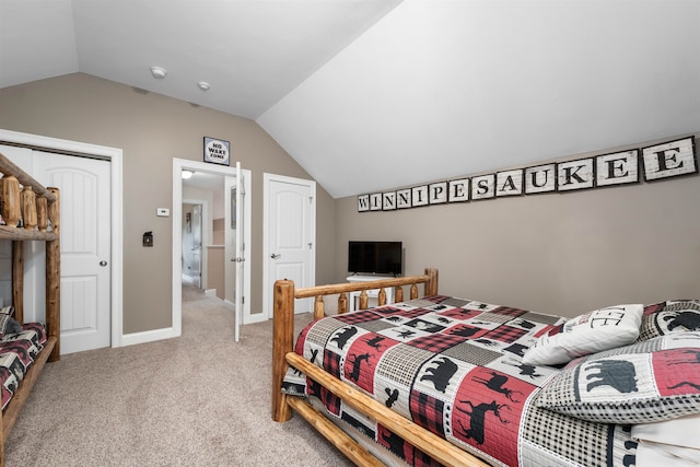 carpeted bedroom featuring lofted ceiling and a closet