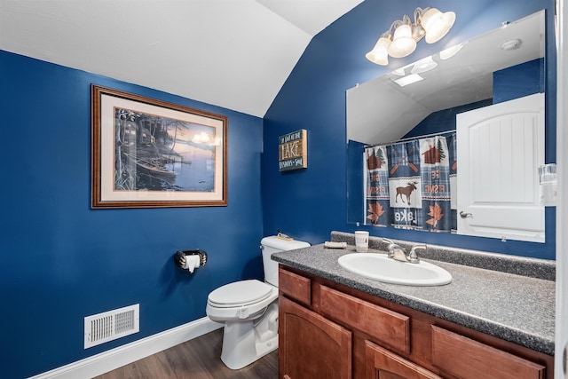 bathroom with a shower with shower curtain, toilet, vaulted ceiling, vanity, and hardwood / wood-style flooring