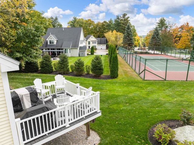 view of tennis court with a lawn