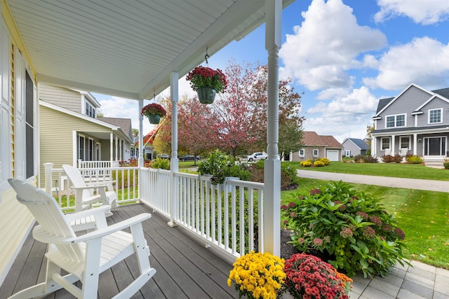 wooden deck with a yard and a porch