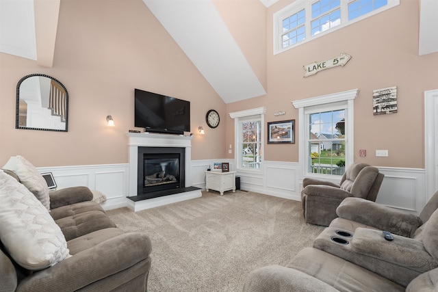 living room with light carpet and a towering ceiling