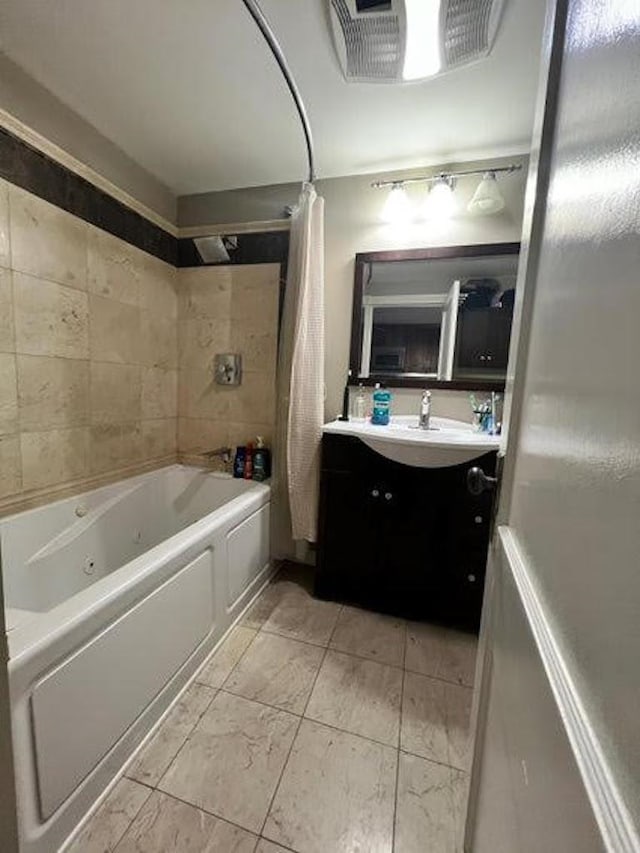 bathroom featuring vanity and shower / bathtub combination with curtain