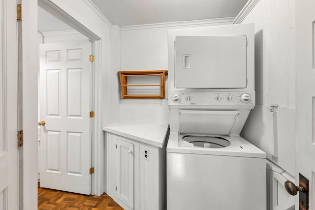 washroom featuring parquet flooring, stacked washing maching and dryer, and crown molding