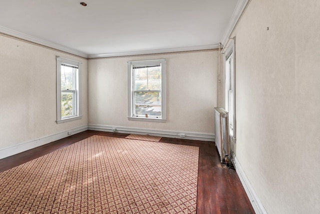 empty room with radiator, ornamental molding, and dark hardwood / wood-style flooring