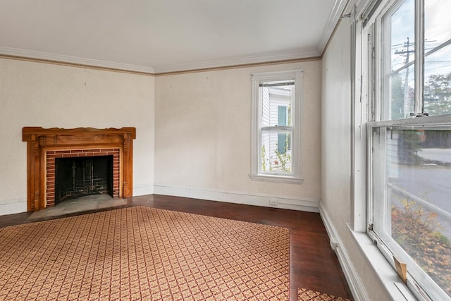 unfurnished living room featuring dark wood-type flooring, ornamental molding, and a brick fireplace