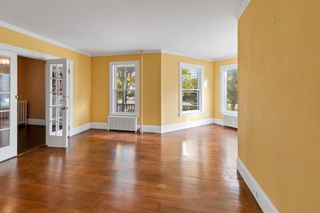 empty room featuring ornamental molding, hardwood / wood-style floors, and radiator