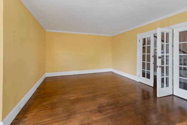 spare room with ornamental molding, french doors, and dark hardwood / wood-style flooring