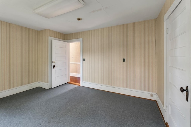 empty room featuring dark carpet