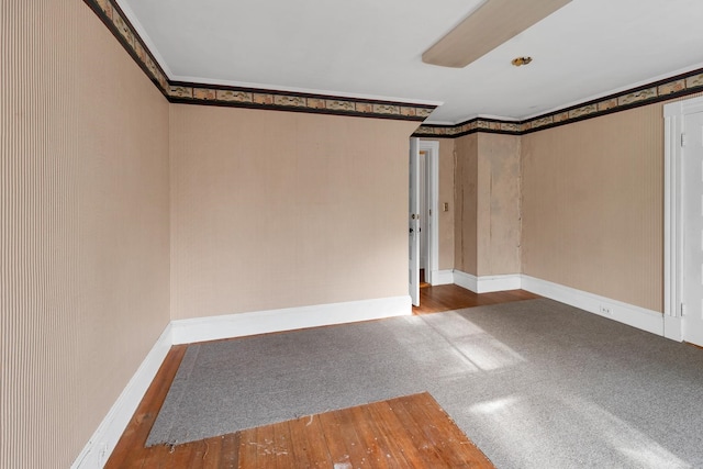 spare room featuring ornamental molding and hardwood / wood-style floors