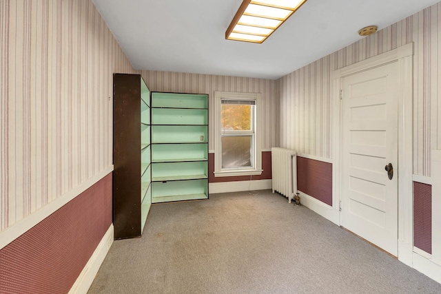 interior space featuring radiator and carpet