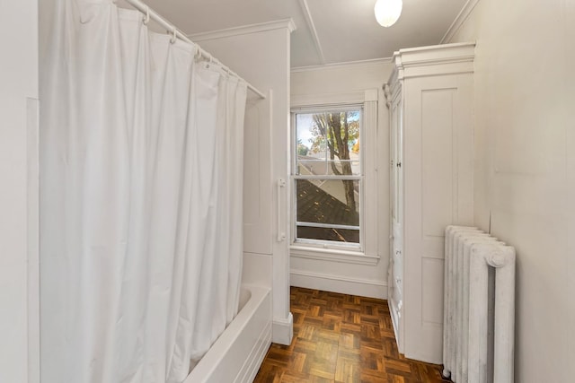 bathroom featuring crown molding, radiator heating unit, shower / tub combo with curtain, and parquet floors