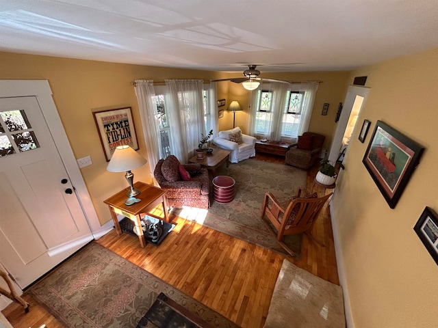 living room with hardwood / wood-style flooring and ceiling fan