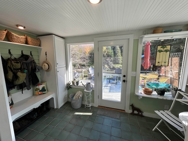 mudroom with dark tile patterned flooring