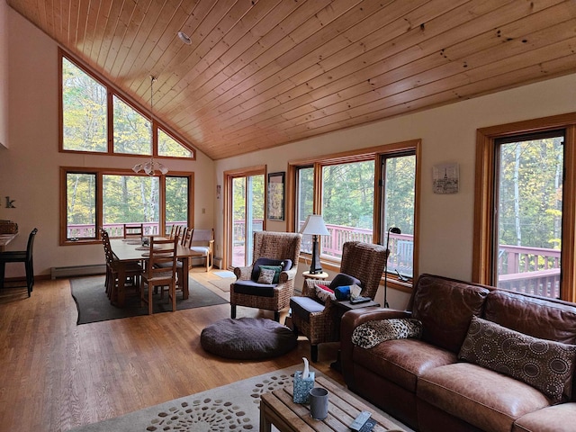 living room with wood ceiling, baseboard heating, wood-type flooring, and a wealth of natural light