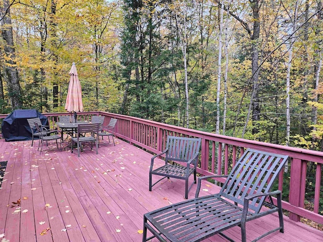 wooden terrace featuring a grill