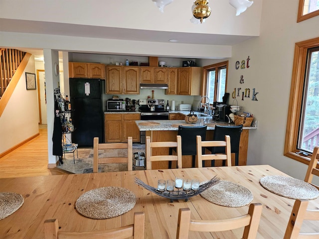 kitchen with light hardwood / wood-style floors, a healthy amount of sunlight, and appliances with stainless steel finishes