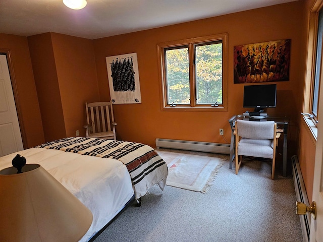 bedroom featuring a baseboard heating unit and carpet floors