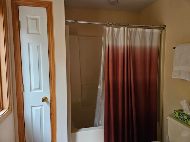 bathroom with toilet and shower / tub combo with curtain