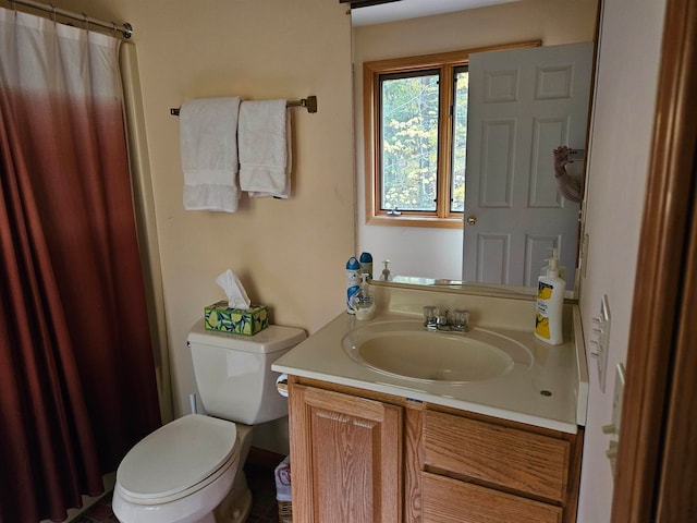 bathroom featuring vanity, a shower with curtain, and toilet